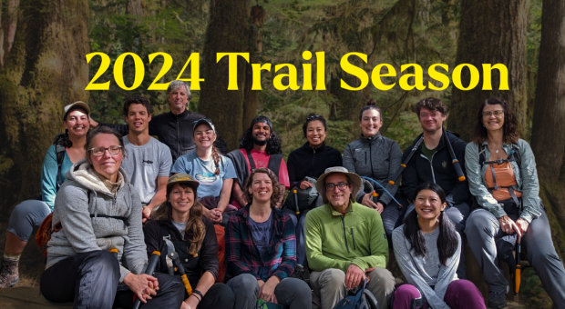 A group of people posing in a forest. Text on the image says "2024 Trail Season". End of image description.