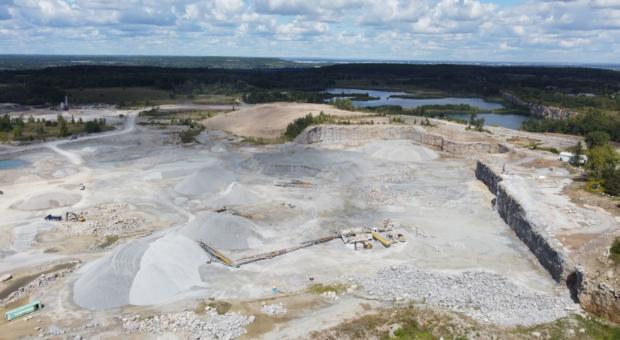 An aerial shot of a gravel mining pit. End of image description. 