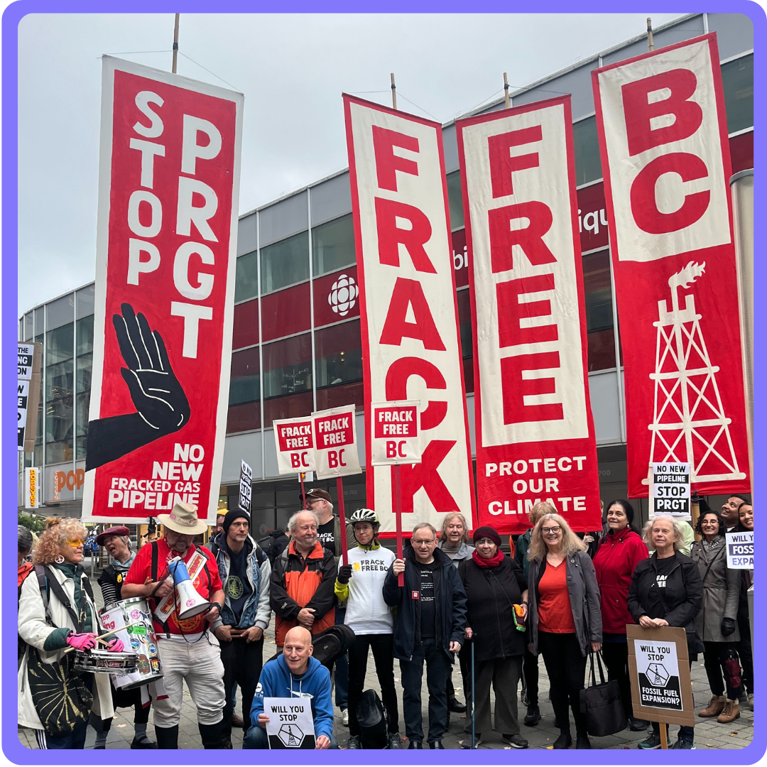 A group of activists protesting with FrackFreeBC banners. end of image description.