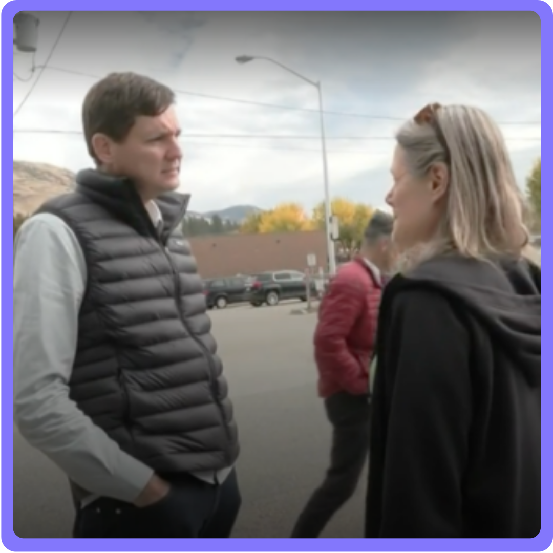 A man and a woman talking. End of image description.