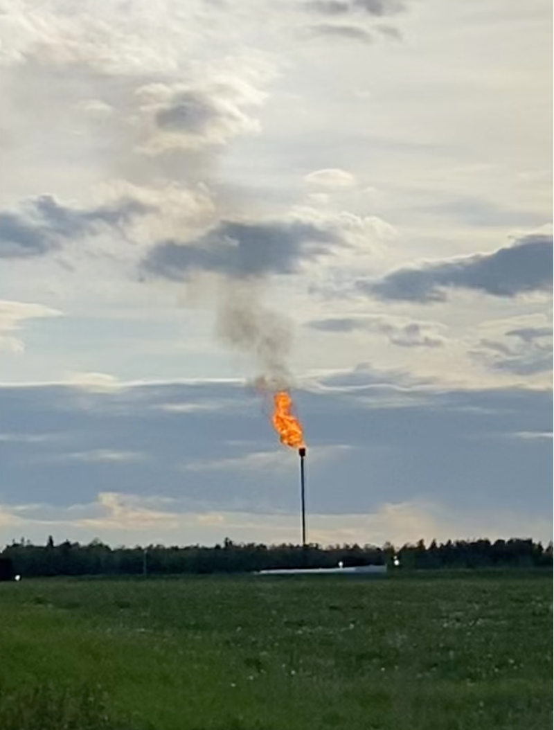 A flare stack burning off excess gas. End of image description.