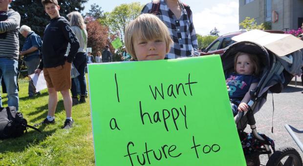 Four-year-old Jonah Arbez holds a protest sign at Friday’s Strike for Climate on the steps of Nanaimo City Hall. (COLE SCHISLER/Black Press)